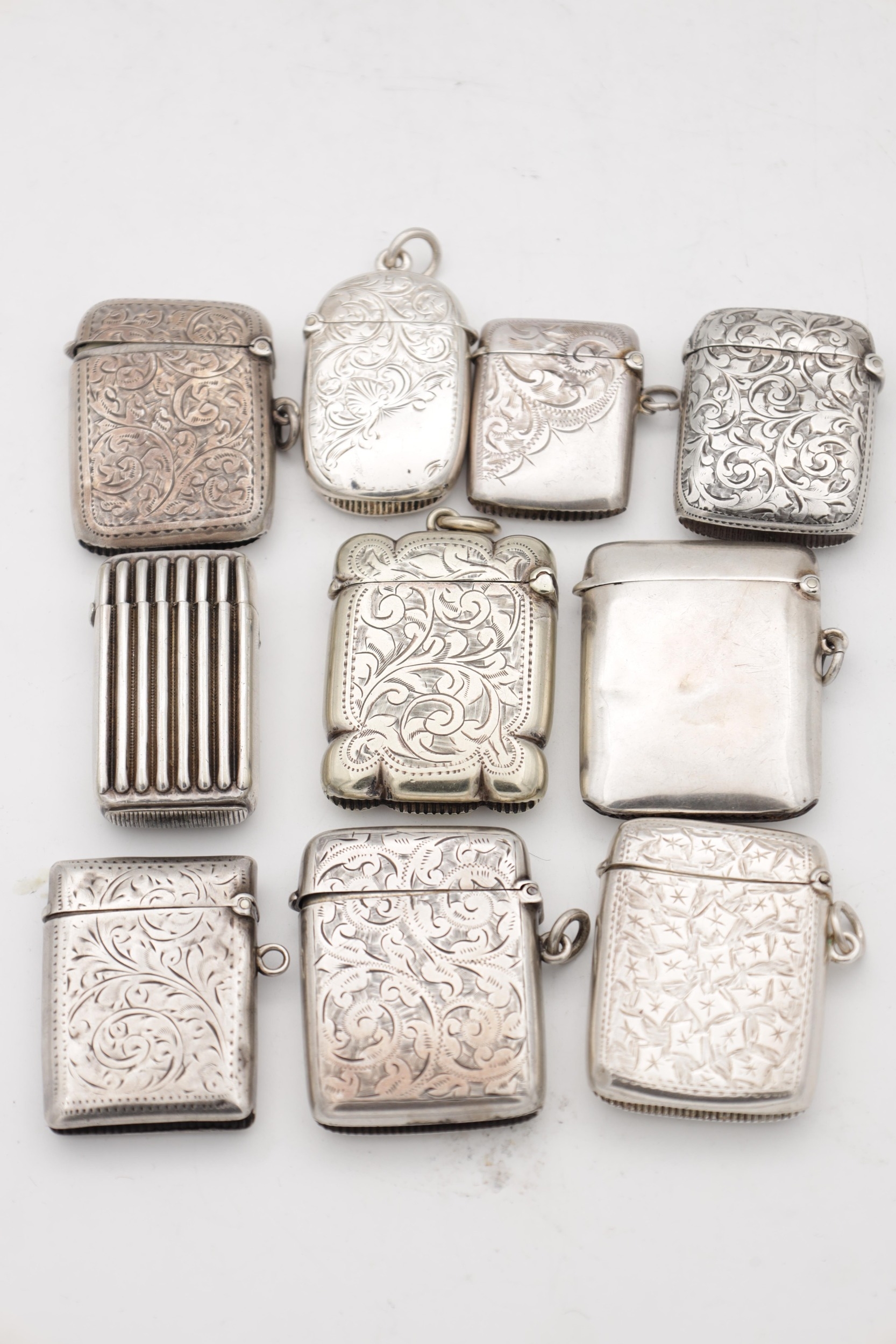 A COLLECTION OF TEN SILVER AND SILVER METAL VESTA CASES comprising ...