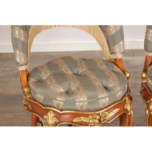 A PAIR OF 19TH CENTURY STYLE FRENCH WALNUT AND PARCEL GILT UPHOLSTERED ...