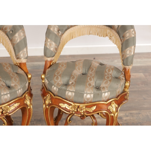A PAIR OF 19TH CENTURY STYLE FRENCH WALNUT AND PARCEL GILT UPHOLSTERED ...
