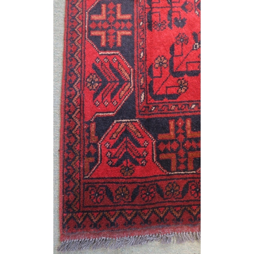 59 - A red ground eastern style runner 294cm long x 83cm wide