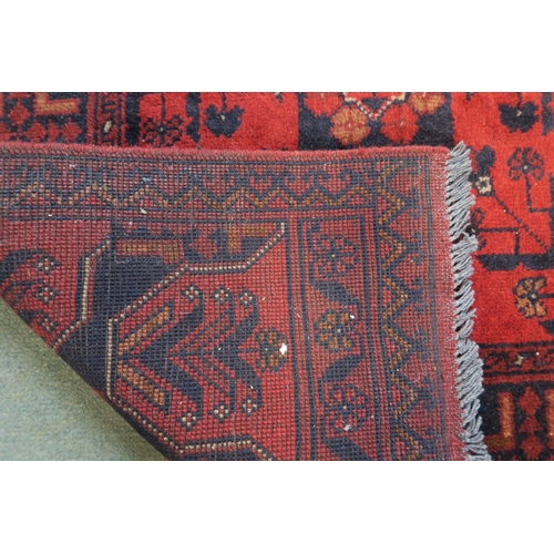 59 - A red ground eastern style runner 294cm long x 83cm wide