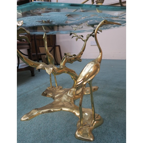 71 - A 20th century oriental style brass bird based glass top lamp table,an oriental circular brass top t... 