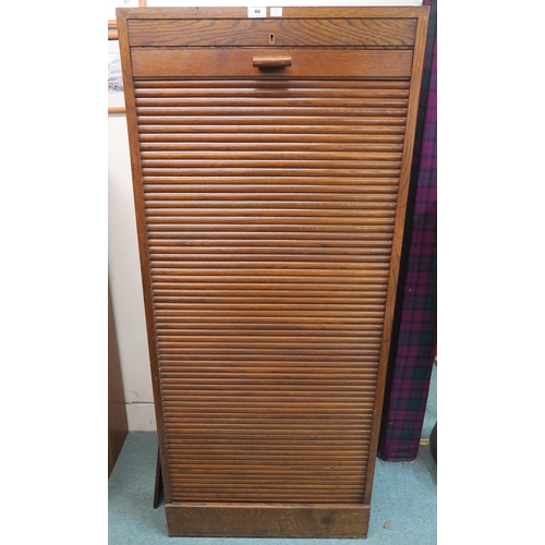 86 - A 20th century oak tambour front filing cabinet 152cm high x 66cm wide x 52cm deep