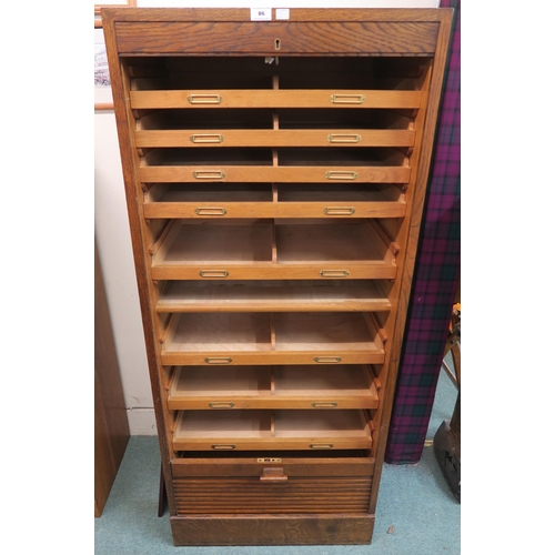 86 - A 20th century oak tambour front filing cabinet 152cm high x 66cm wide x 52cm deep