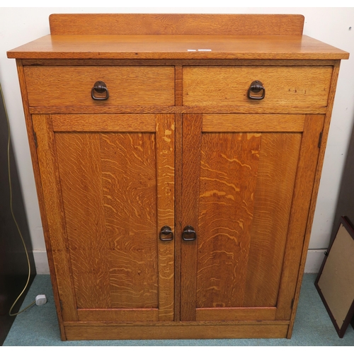 88 - An early 20th century Taylor & Whitfield ltd oak two door cabinet with bronzed door furniture 125cm ... 