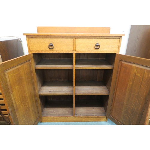 88 - An early 20th century Taylor & Whitfield ltd oak two door cabinet with bronzed door furniture 125cm ... 