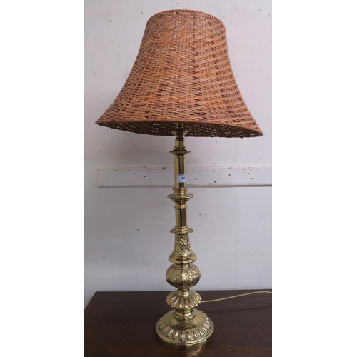 89 - A 20th century cast brass table lamp with wicker lamp shade