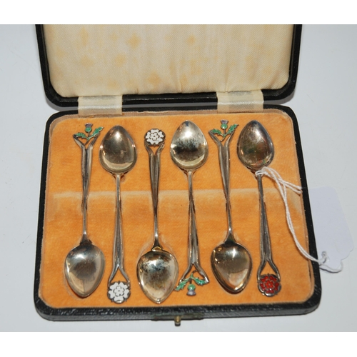 806 - A cased set of six silver coffee spoons with enamel terminals, thistle, rose etc. Birmingham 1937