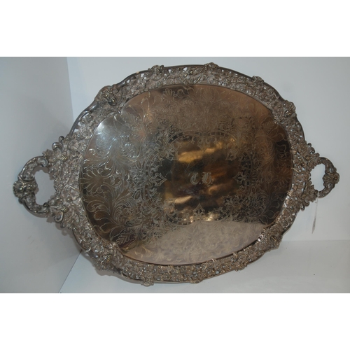 814 - A silver plated twin handles serving tray, oval with pierced rim with fruit and vine embossed decora... 