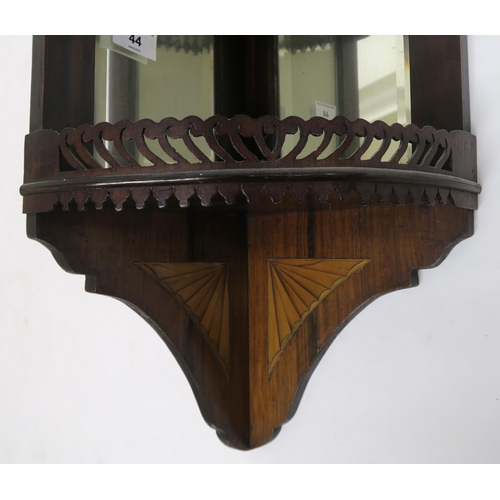 44 - An Edwardian mahogany and satinwood inlay mirrored corner shelf with to fretwork galleried shelves, ... 