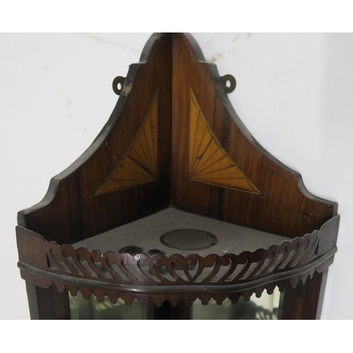 44 - An Edwardian mahogany and satinwood inlay mirrored corner shelf with to fretwork galleried shelves, ... 