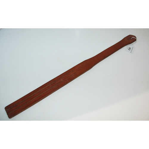 362 - A brown leather Lochgelly tawse by John. J. Dick