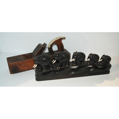 372 - A graduated carved ebony set of elephants, 38cm wide and a vintage wood plane (2) 