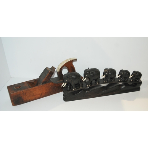 372 - A graduated carved ebony set of elephants, 38cm wide and a vintage wood plane (2) 