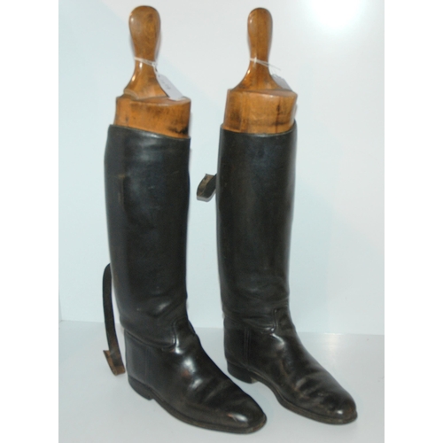 404 - A pair of black leather riding boots, 26cm heel to toe