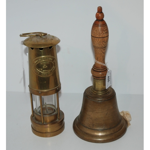 406 - A brass hand bell and E. Thomas & Williams Ltd Cambrian lamp (2)