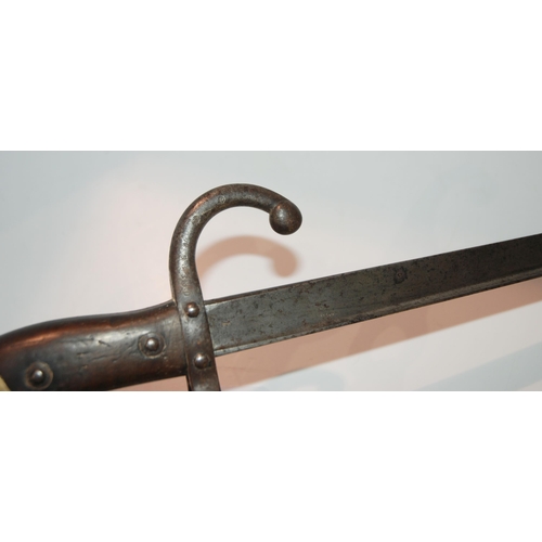 437 - A French bayonet, the blade inscribed, the guard and metal scabbard numbered AC 47793 and another, t... 