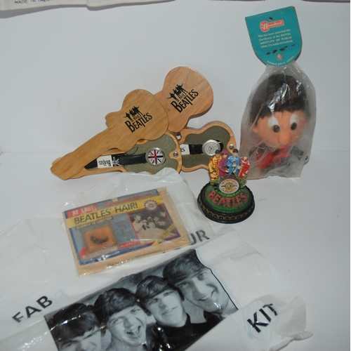 463 - A tray lot of Beatles memorabilia including Rosebud Paul McCartney doll in original packaging, tea t... 