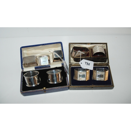 730 - Two pairs of cased silver napkin rings, Birmingham 1919 and 1934, a single cased napkin ring and loo... 