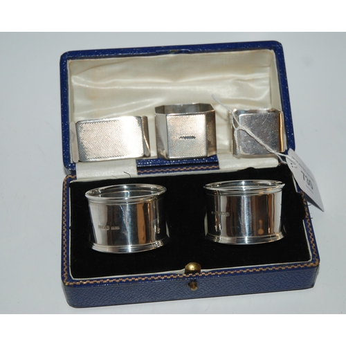 730 - Two pairs of cased silver napkin rings, Birmingham 1919 and 1934, a single cased napkin ring and loo... 