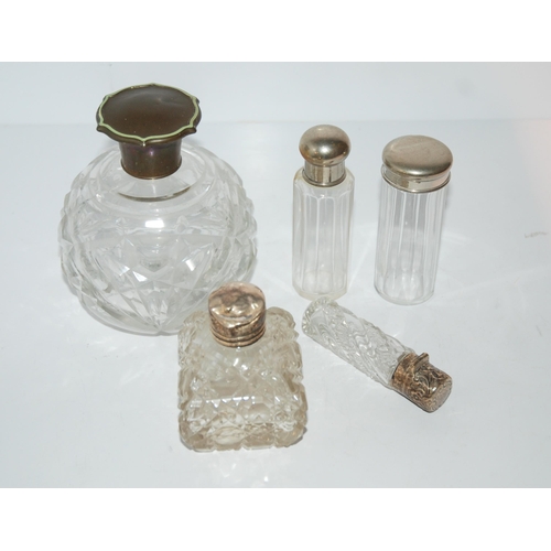 746 - A faux tortoiseshell topped scent bottle, two silver-topped scent bottles and two white-metal topped... 