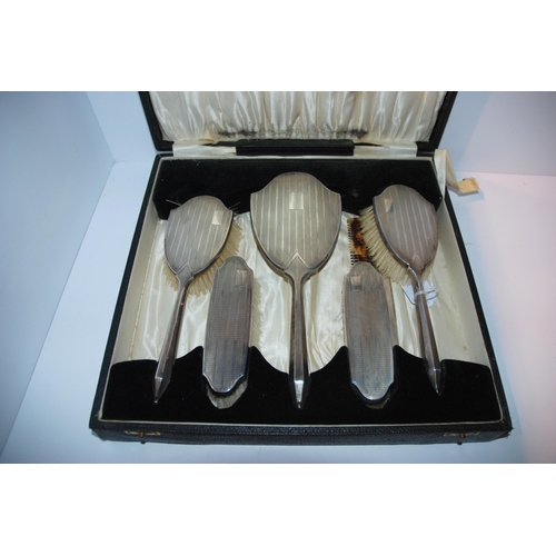 755 - A cased five piece silver backed dressing table set, Birmingham 1932