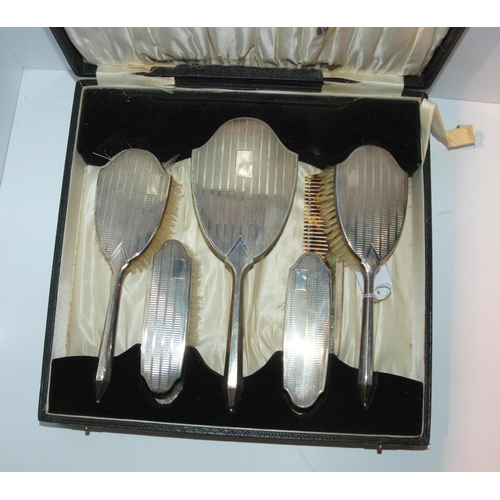 755 - A cased five piece silver backed dressing table set, Birmingham 1932