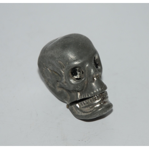 773 - A metal vesta modelled as a human skull, 4.5cm high