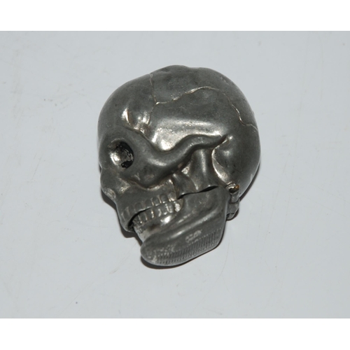 773 - A metal vesta modelled as a human skull, 4.5cm high