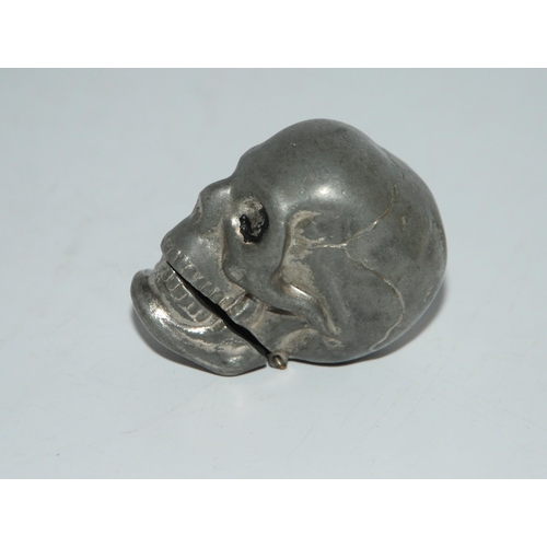 773 - A metal vesta modelled as a human skull, 4.5cm high