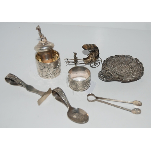 784 - A mixed lot of white-metal items filigree dish, bottle pourer, rickshaw, two napkin rings, spoon and... 