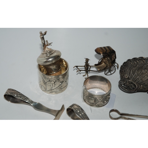 784 - A mixed lot of white-metal items filigree dish, bottle pourer, rickshaw, two napkin rings, spoon and... 