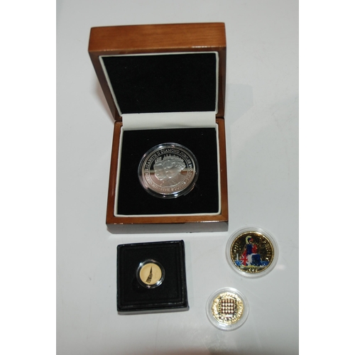 813 - A lot comprising a cased Gibraltar silver five pound coin, two gilded coins and a Concorde gold quar... 