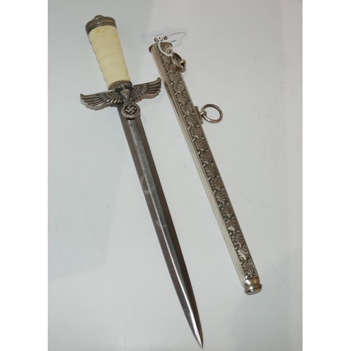 819 - A replica WW2 style German political leader's dagger in scabbard 41 cm o/all length