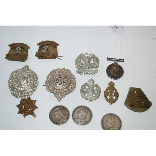 824 - A lot comprising a WW1 War medal to 193303 Dvr A Walker RA, assorted military badges and three Victo... 