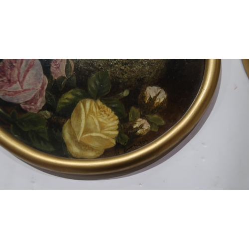 867 - M E Birds nest, eggs and flowers, signed, oil on board, 23cm diameter (2)