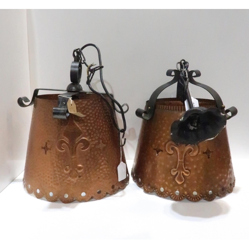 228 - A similar pair of hammered copper ceiling lights decorated with pierced circular rim, pierced stars ... 