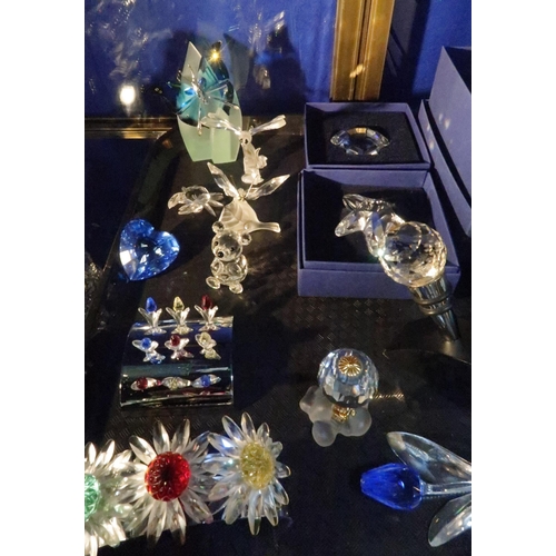 245 - A collection of Swarovski items including butterflies, flowers, starfish, heart, bottle stoppers and... 