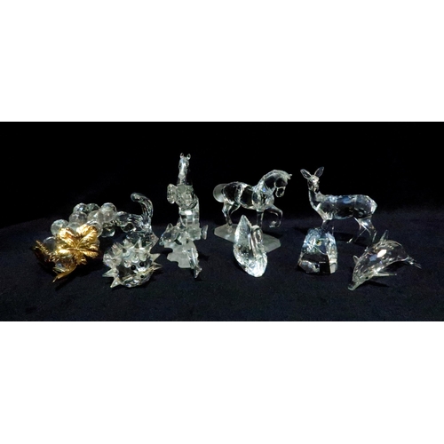 246 - A collection of Swarovski figures including a rearing horse, standing horse, deer, eagles head, bunc... 