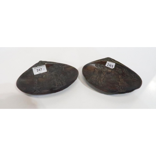 247 - A pair of bronzed spelter shell shaped dishes with decoration of geishas in a landscape