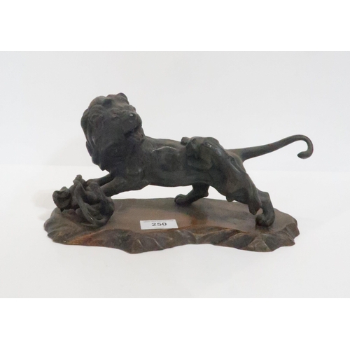 250 - A spelter figure group of a lion being attacked by tigers, upon wooden base