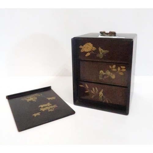 260 - A Japanese gilt lacquered jewellery/trinket box with three inserts, decorated to each side with flow... 