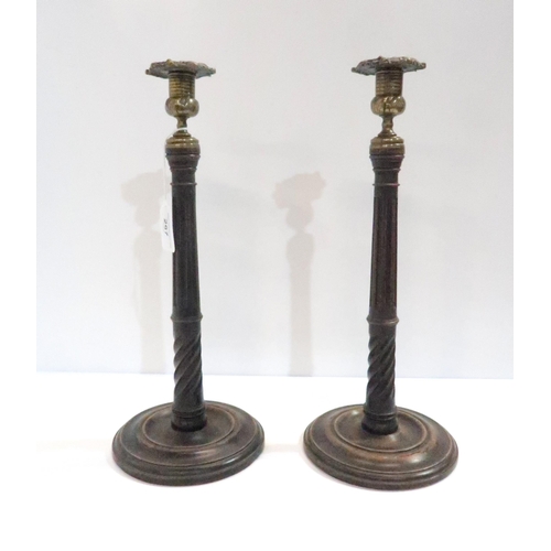 267 - A pair of antique wood and brass candlesticks