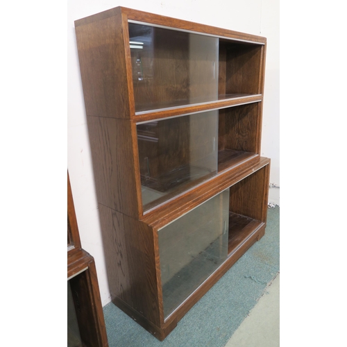 101 - A 20th century oak three tier stacking bookcase with glass sliding doors, 107cm high x 89cm wide x 2... 