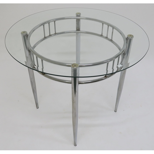 106 - A 20th century chrome and glass topped circular dining table and a contemporary cut glass table lamp... 