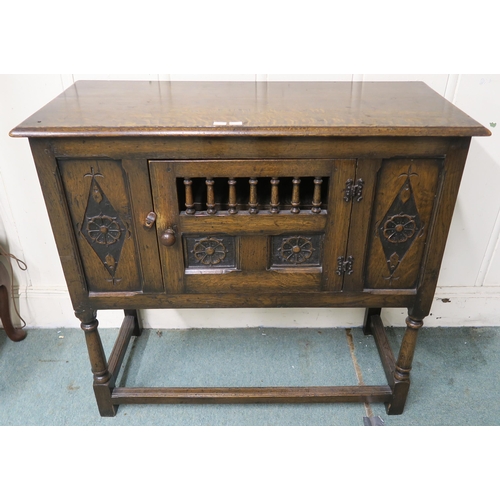 11 - A 20th century stained oak single door side cabinet with carved rose reliefs, 84cm high x 92cm wide ... 
