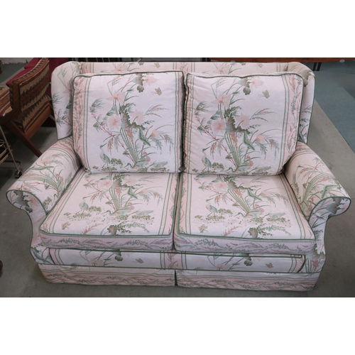 110 - A 20th century floral upholstered wing back two seater settee, 88cm high x 143cm wide x 98cm deep