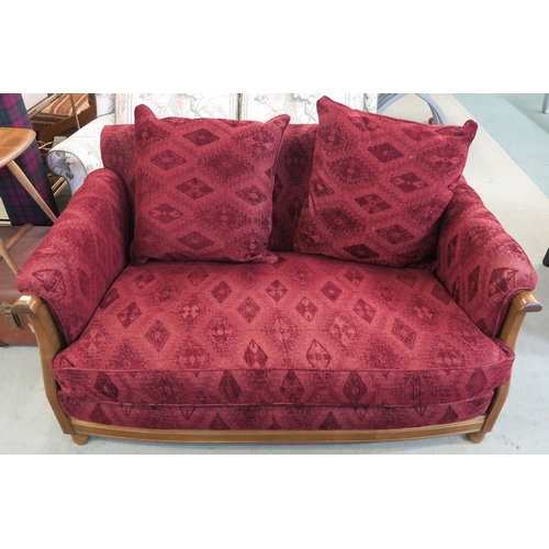 118 - A 20th century beech framed Ercol two seater sofa with red patterned upholstery, 77cm high x 144cm w... 