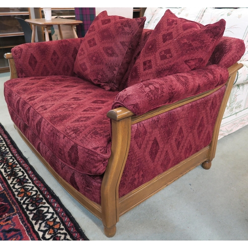 118 - A 20th century beech framed Ercol two seater sofa with red patterned upholstery, 77cm high x 144cm w... 