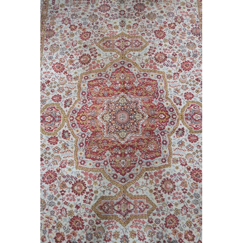 120 - A 20th century beige ground Axminster style rug with a red central medallion and border, 356cm long ... 